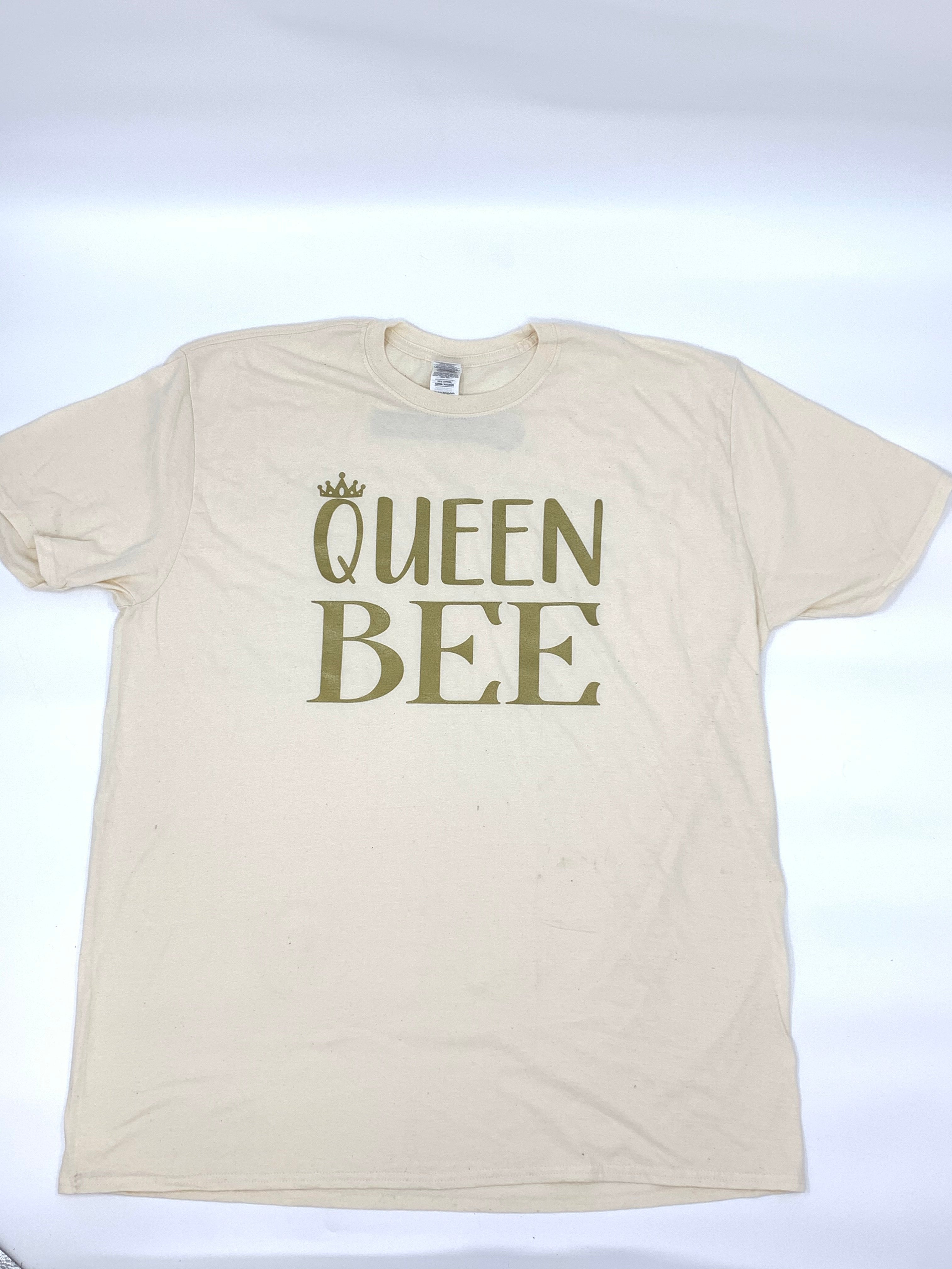 Shimmering gold letters spelling 'Queen Bee' on a vibrant background