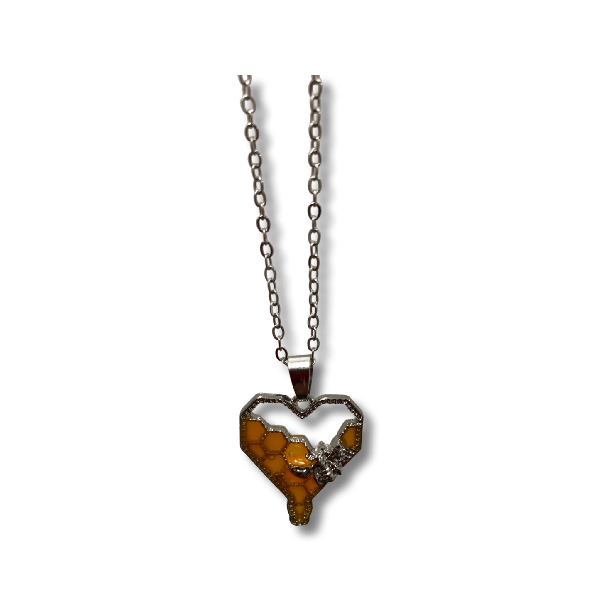 Elegant silver necklace with a heart-shaped honeycomb pendant.